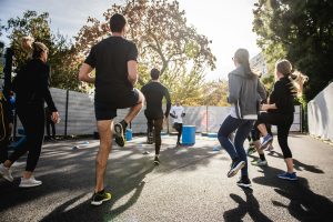 fitness class lead by instructor who knows that he needs fitness instructor insurance